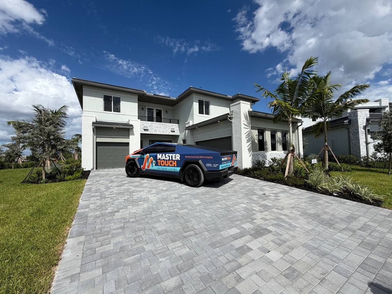 A new two-story home in Parkland Royale with the Master Touch truck in the paver driveway